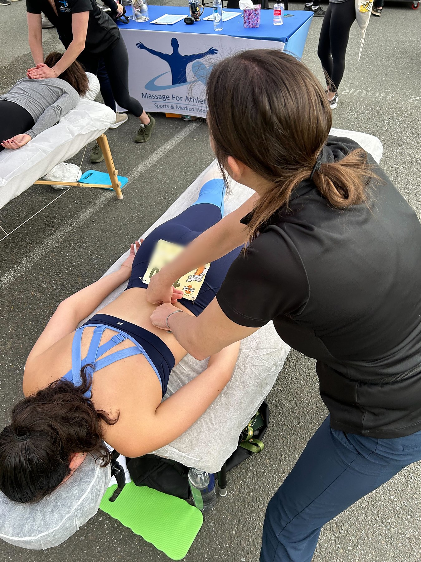 An MFA therapist giving sports massage at a race event